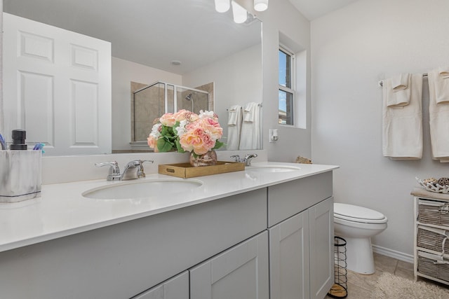 bathroom with toilet, vanity, tile patterned floors, and a shower with door