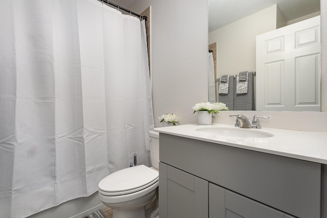 full bathroom with shower / bath combo with shower curtain, vanity, and toilet