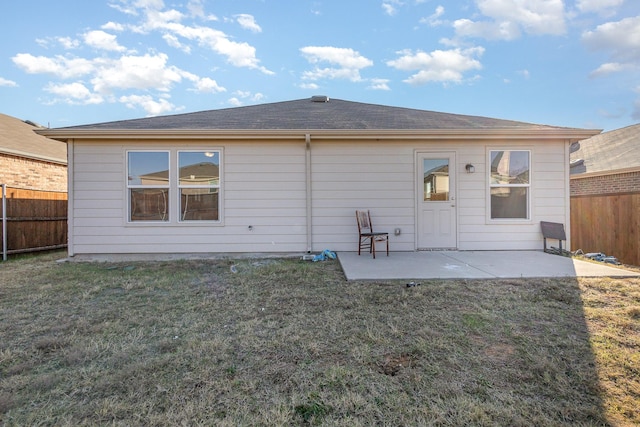 rear view of property with a yard and a patio area