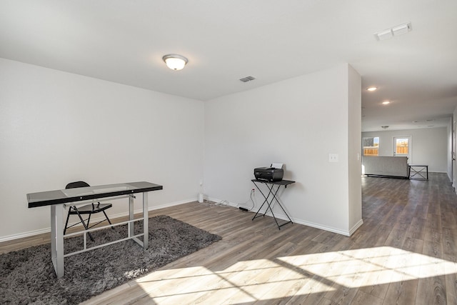 home office with hardwood / wood-style flooring