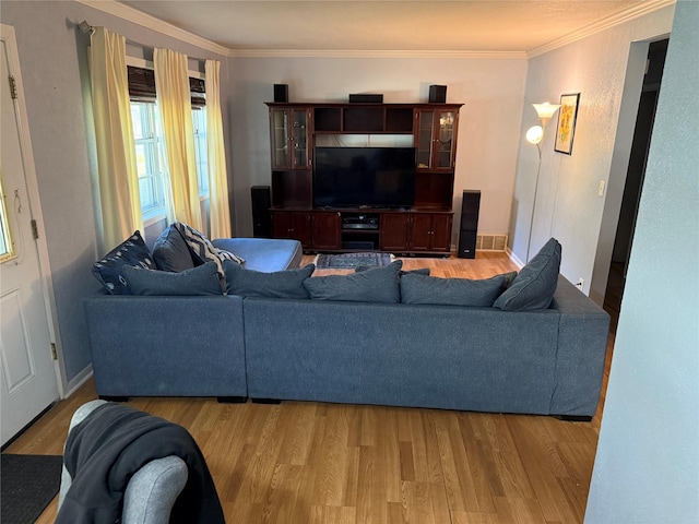 living room with light hardwood / wood-style flooring and crown molding