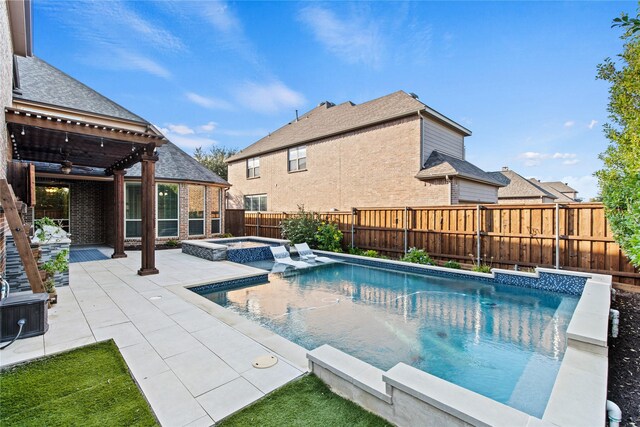 view of swimming pool featuring a patio area, ceiling fan, and an in ground hot tub