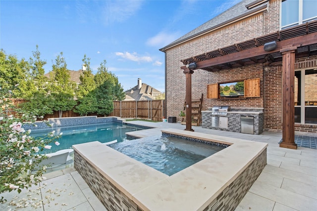 view of swimming pool featuring an outdoor kitchen, a patio area, and grilling area