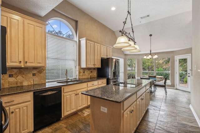 kitchen featuring sink, black appliances, pendant lighting, a chandelier, and a kitchen island