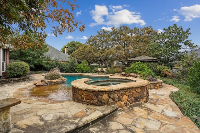 view of swimming pool featuring a gazebo, an in ground hot tub, and a patio