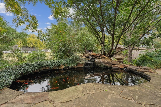 view of pool featuring a small pond