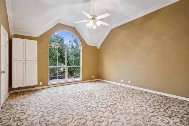 carpeted empty room featuring a textured ceiling, lofted ceiling, ceiling fan, and crown molding