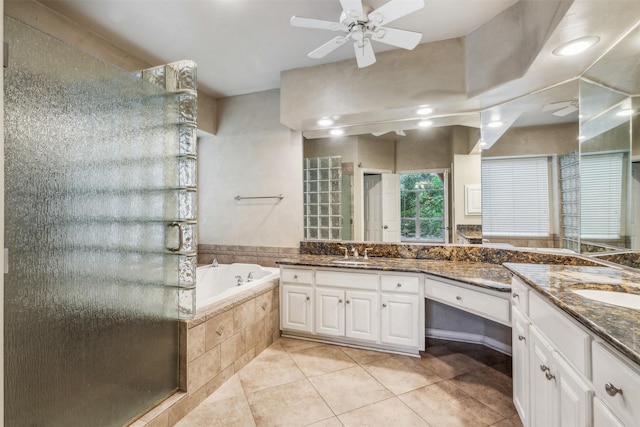 bathroom with tile patterned floors, ceiling fan, separate shower and tub, and vanity