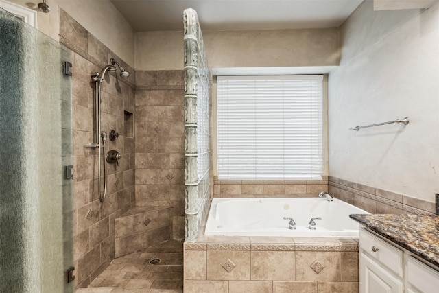 bathroom featuring vanity and shower with separate bathtub