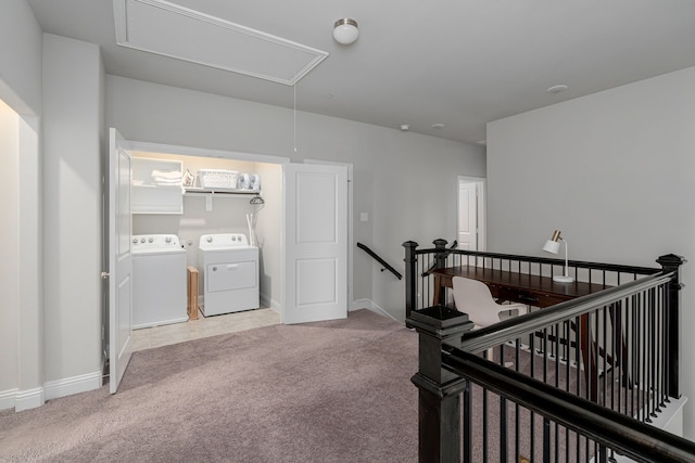 hallway with washer and clothes dryer and light colored carpet