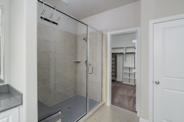 bathroom featuring tile patterned flooring and a shower with door