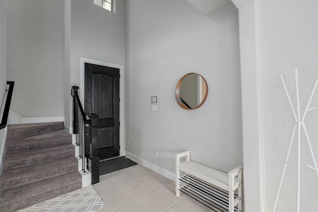 foyer with light tile patterned flooring and a high ceiling