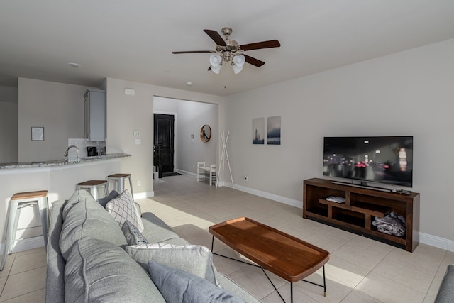 living room featuring light tile patterned floors and ceiling fan