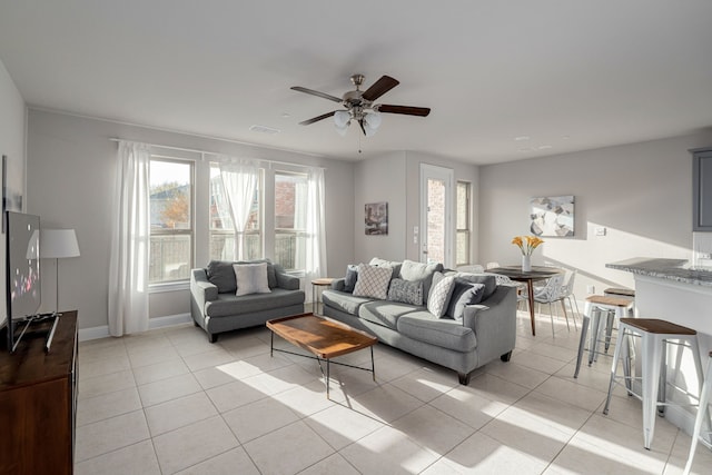 tiled living room with ceiling fan