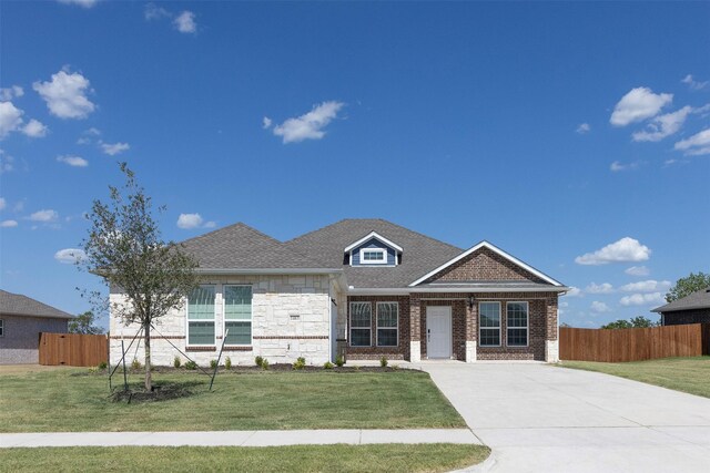 view of front of house featuring a garage and a front lawn