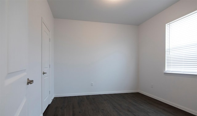 unfurnished room with dark hardwood / wood-style floors