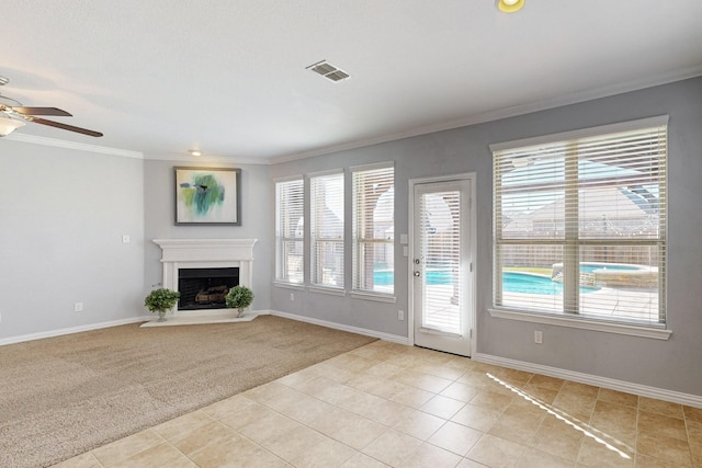 unfurnished living room with light carpet, ceiling fan, and ornamental molding