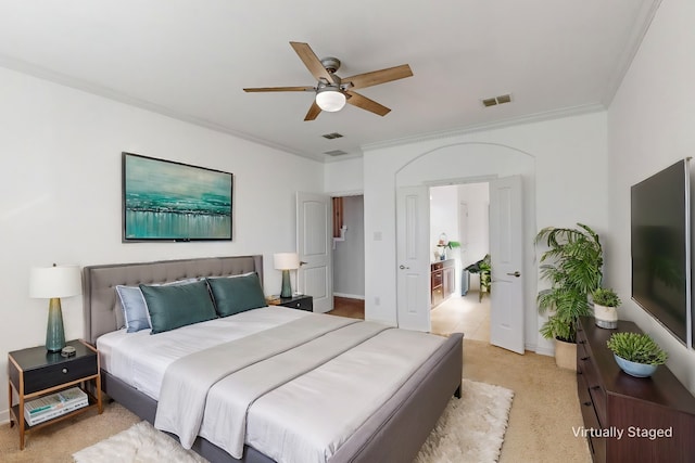 carpeted bedroom featuring ceiling fan and crown molding