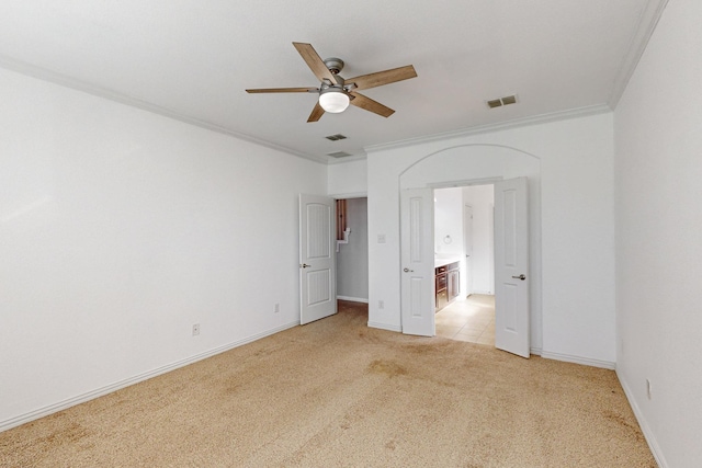 unfurnished bedroom featuring ceiling fan, light colored carpet, and ornamental molding