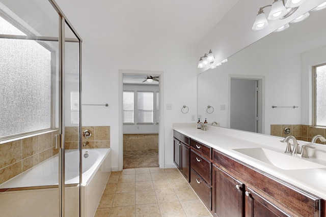 bathroom featuring vanity, tile patterned floors, ceiling fan, and tiled tub