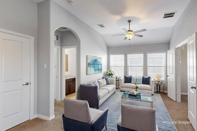 carpeted living room featuring ceiling fan and vaulted ceiling