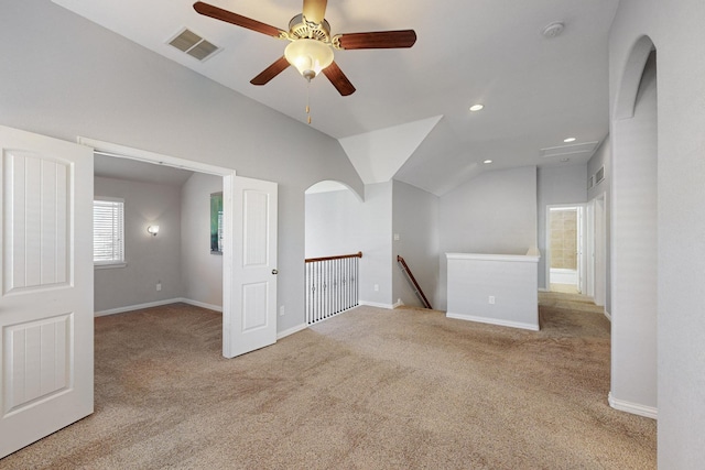 additional living space featuring light carpet, ceiling fan, and vaulted ceiling