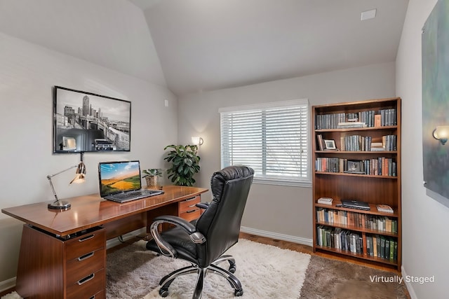 home office with wood-type flooring and lofted ceiling