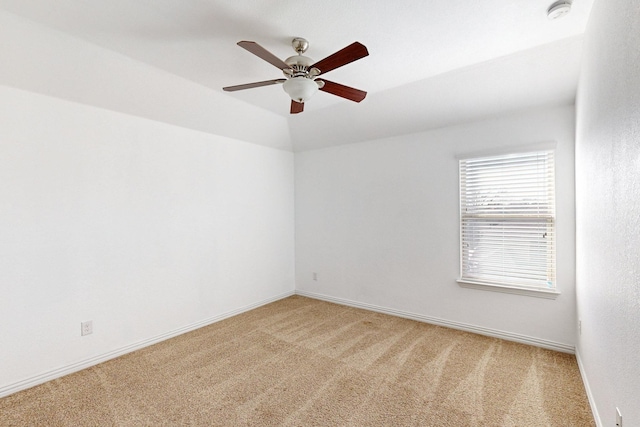 empty room with ceiling fan and carpet floors