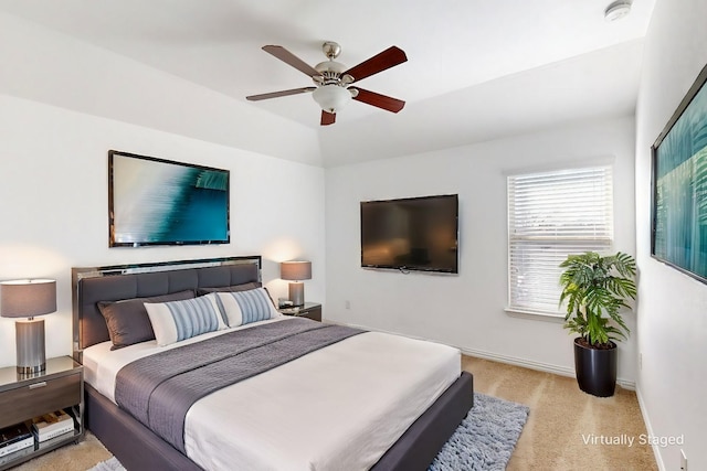 bedroom with light colored carpet, ceiling fan, and lofted ceiling