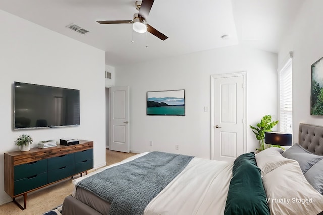 bedroom with ceiling fan, light colored carpet, and lofted ceiling