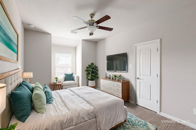 bedroom with ceiling fan and light carpet