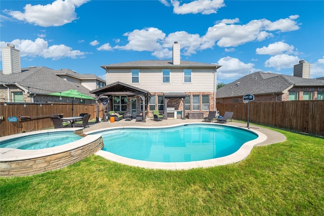 view of pool featuring an in ground hot tub, a gazebo, a yard, and a patio area