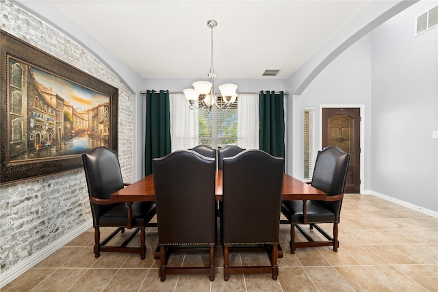 tiled dining area featuring a notable chandelier