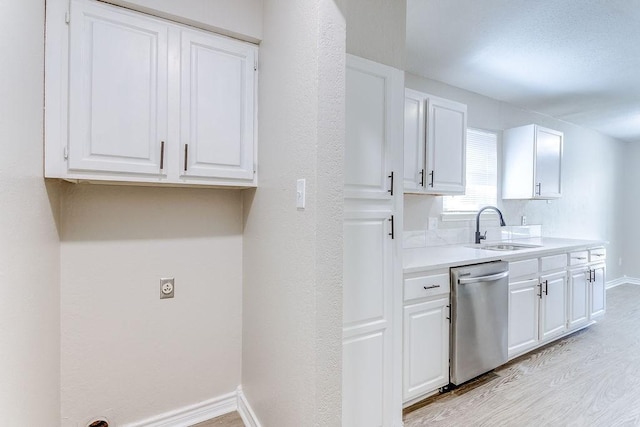 kitchen with light hardwood / wood-style floors, dishwasher, sink, and white cabinets