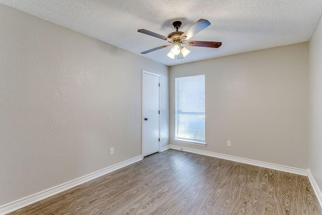 unfurnished room featuring ceiling fan, a textured ceiling, and light wood-type flooring