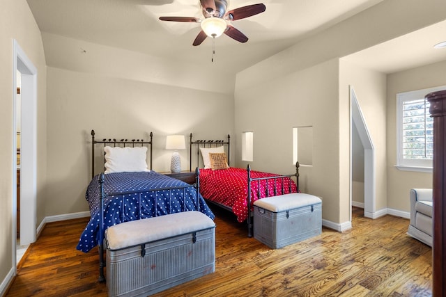 bedroom with ceiling fan and dark wood-type flooring