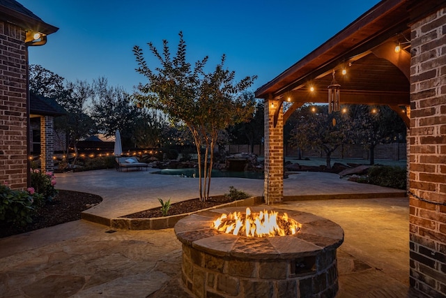 patio terrace at dusk with an outdoor fire pit