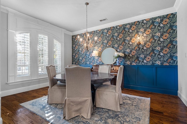 dining area with an inviting chandelier, dark hardwood / wood-style floors, and ornamental molding