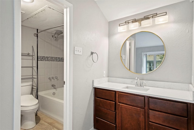 full bathroom featuring vanity, toilet, and tiled shower / bath