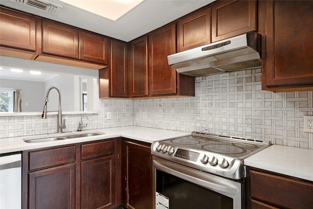 kitchen with decorative backsplash, sink, and appliances with stainless steel finishes