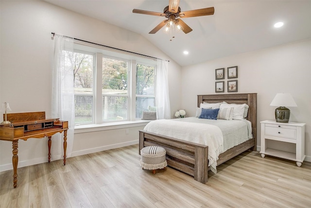 bedroom featuring ceiling fan, light wood-type flooring, and lofted ceiling