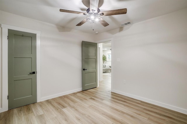 empty room featuring ceiling fan and light wood-type flooring