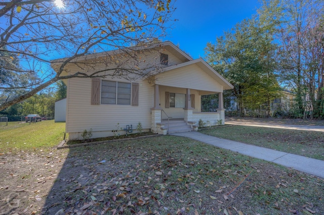 bungalow-style house with a front lawn and a porch