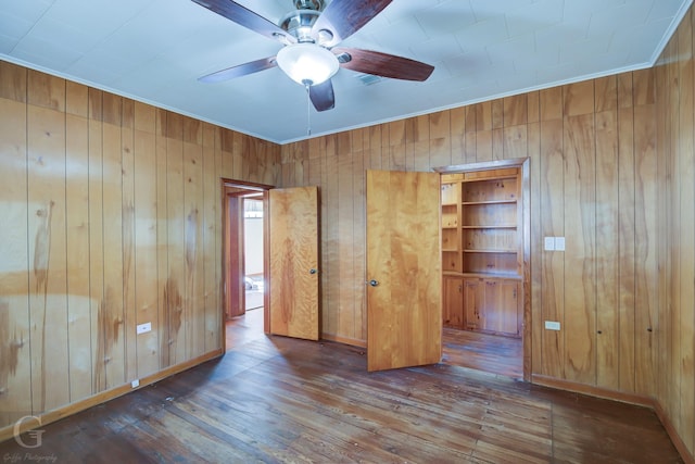 unfurnished bedroom featuring dark hardwood / wood-style floors and wood walls