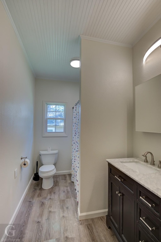 bathroom featuring hardwood / wood-style floors, vanity, ornamental molding, wood ceiling, and toilet