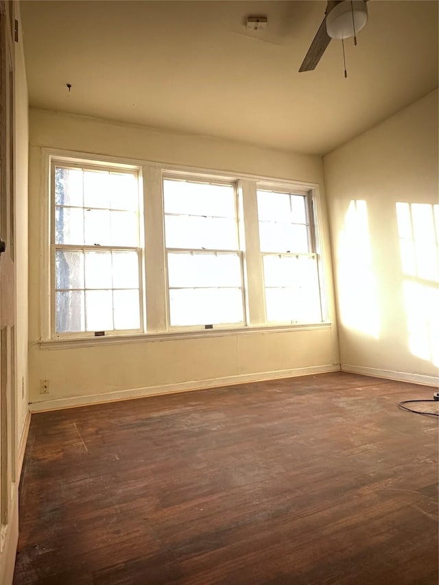 unfurnished room with ceiling fan, dark hardwood / wood-style flooring, a wealth of natural light, and vaulted ceiling