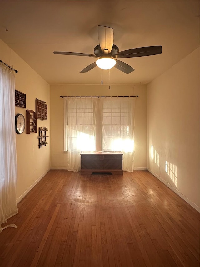 spare room featuring ceiling fan and hardwood / wood-style flooring