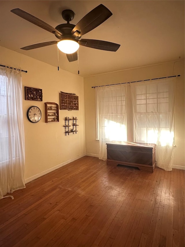 spare room with hardwood / wood-style flooring and ceiling fan