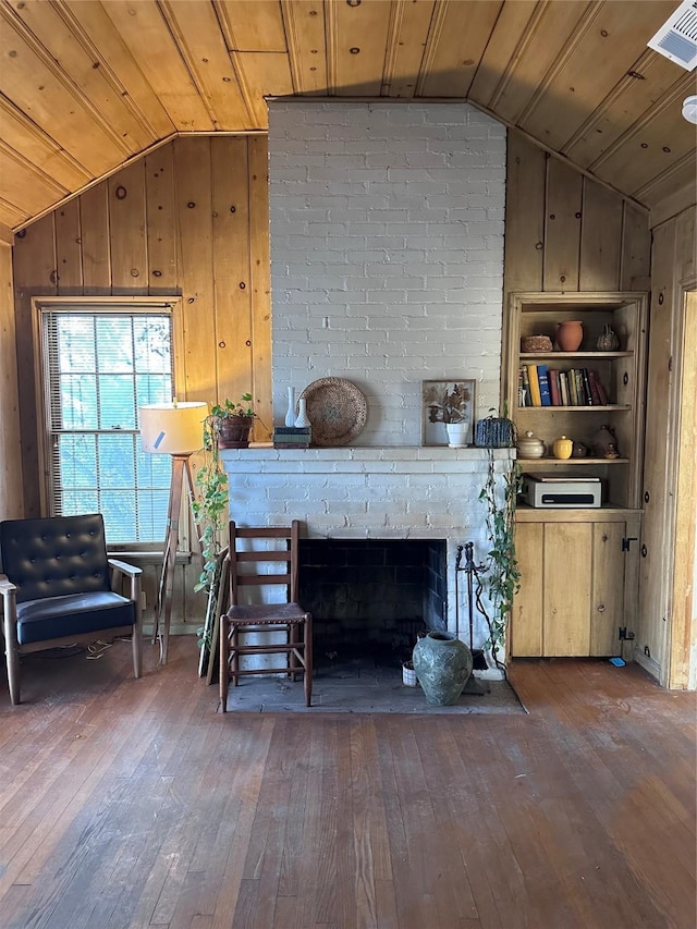 living room featuring built in shelves, vaulted ceiling, wood ceiling, and wood-type flooring