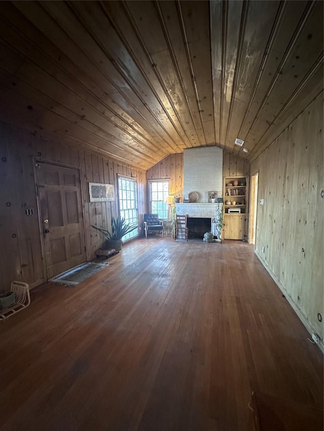 unfurnished living room featuring hardwood / wood-style floors, wooden ceiling, lofted ceiling, and a brick fireplace